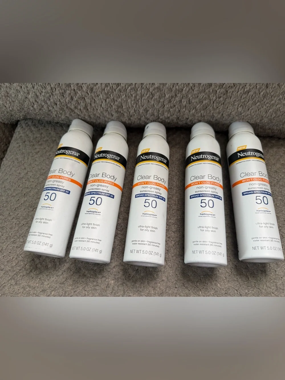 Neutrogena Clear Body SPF 50 Sunscreen Spray — White with Orange Accents